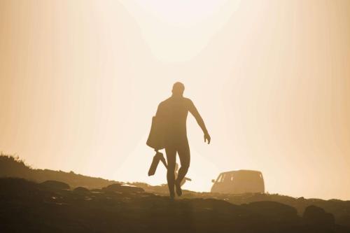 guy waling in the sunset 